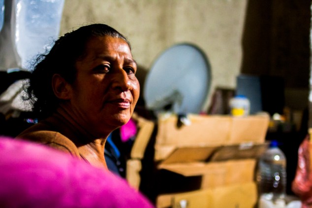 Una mujer posa mientras espera la orden para bajar sus cajas e iniciar el desalojo